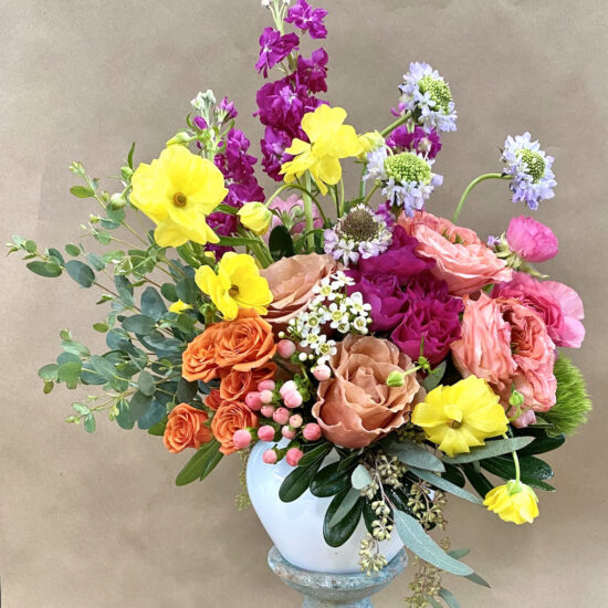 beautiful flower arrangement in a vase on a stand