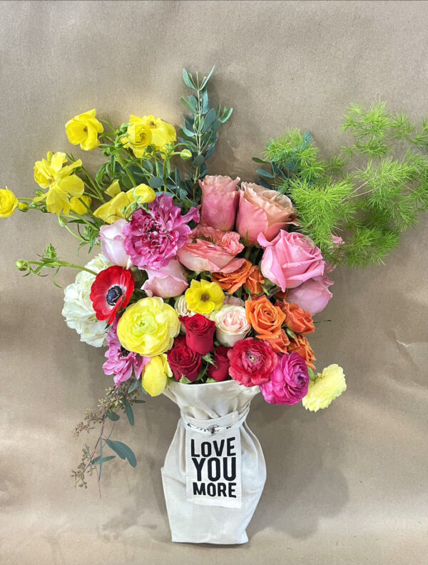 bouquet for a special occasion with sign that says "love you more"