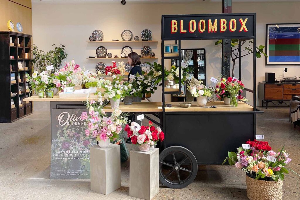 olive's bloombox mobile flower cart in a shop